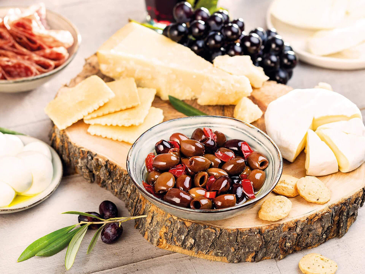 Plateau avec du fromage et des olives épicées